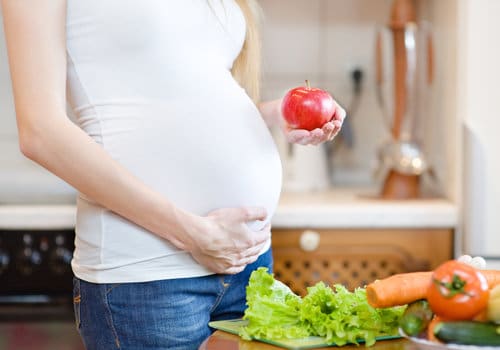 pregnant woman with fruits and vegetables