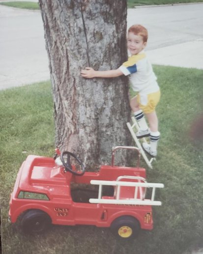 Brendan as a child playing and climbing tree