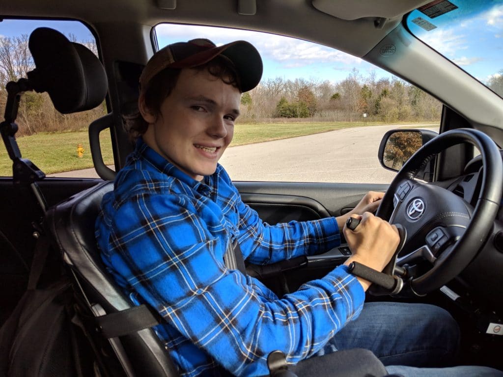 mason in power wheelchair driving his adaptive vehicle