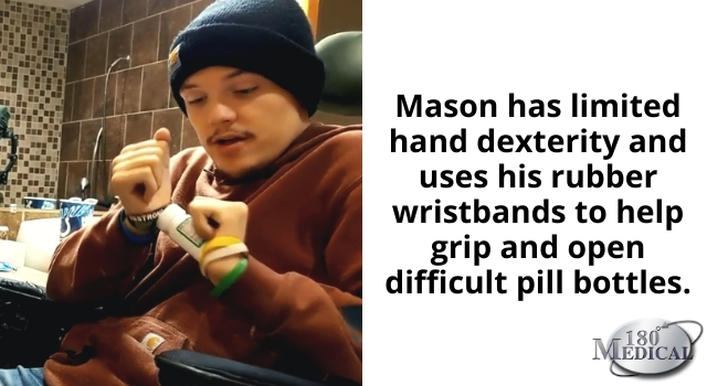 Mason using his wristbands as an adaptive pill bottle opener