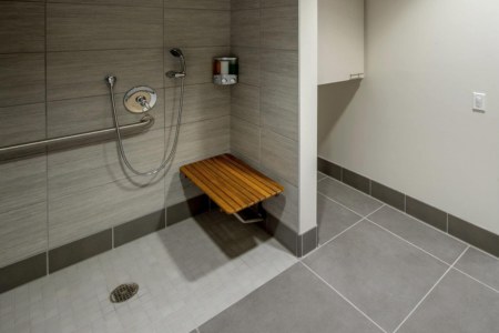 An example of a barrier-free accessible roll-in shower with a bench